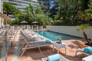 Seasonal outdoor pool, open 9:00 AM to 9:00 PM, pool umbrellas