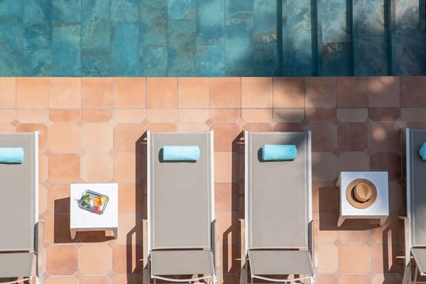 Seasonal outdoor pool, open 9:00 AM to 9:00 PM, pool umbrellas
