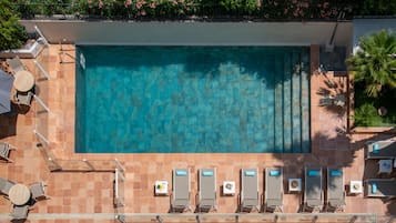 Seasonal outdoor pool, open 9:00 AM to 9:00 PM, pool umbrellas