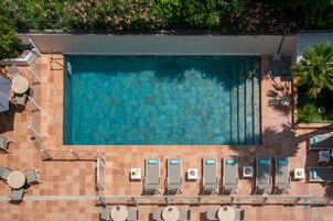 Seasonal outdoor pool, open 9:00 AM to 9:00 PM, pool umbrellas