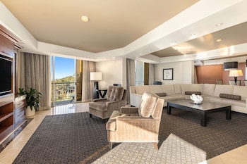 Suite, 1 King Bed (The Champion Suite) | Living area | 55-inch flat-screen TV with cable channels, TV, pay movies at Hilton La Jolla Torrey Pines
