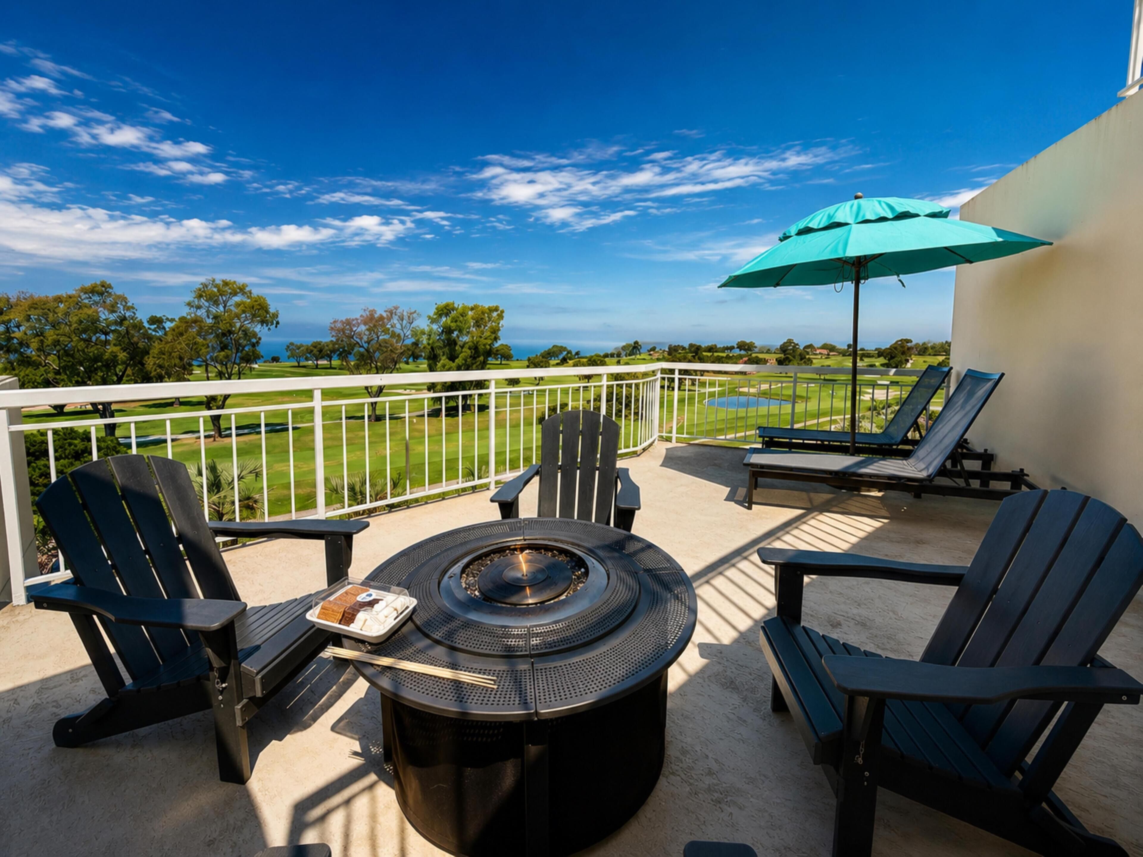 A balcony with a round table, chairs, and a grill.