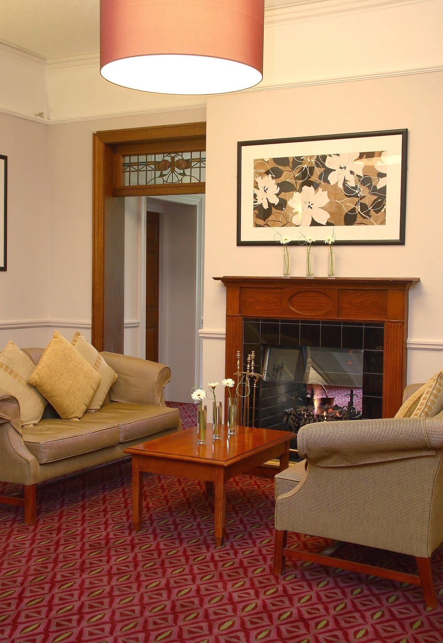 A living room with a fireplace, a sofa, a chair, and a coffee table.