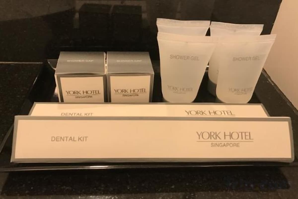 A dental kit with shower gel and a sign for York Hotel Singapore.