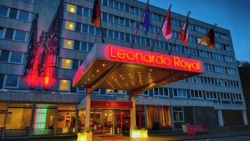A hotel with a prominent red marquee sign reading "Leonardo Royal."