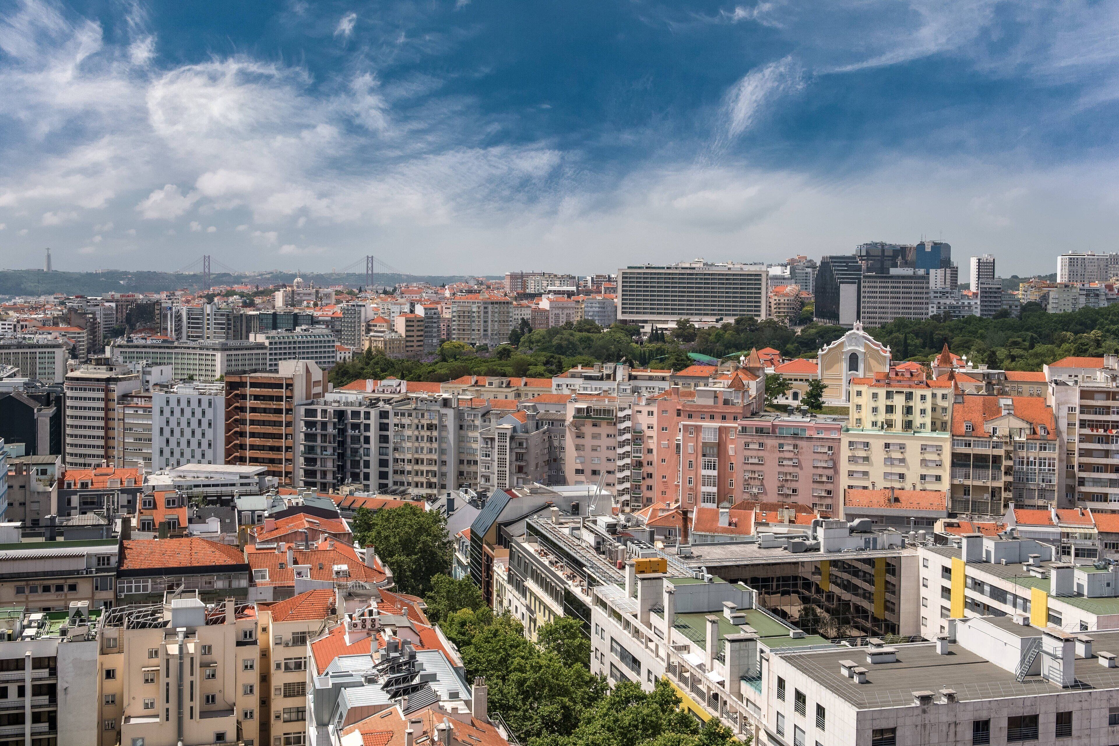 A cityscape with a variety of buildings, including high-rise structures and smaller residential buildings.