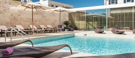 Outdoor pool, open 8:00 AM to 8:00 PM, pool umbrellas, pool loungers