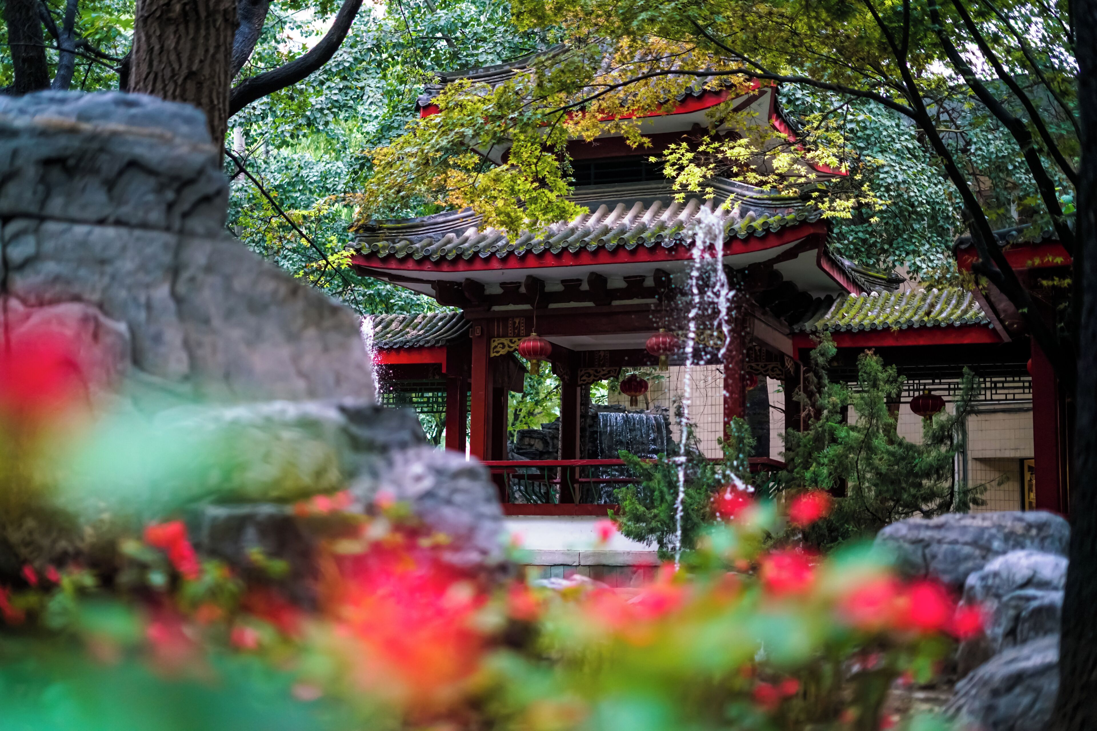 A traditional Japanese-style building with a water feature in front.