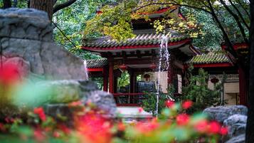 A traditional Japanese-style building with a water feature in front.