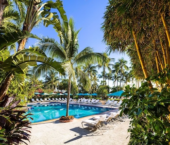 Outdoor pool, a heated pool, open 8:00 AM to 8:00 PM, pool umbrellas at The Palms Hotel & Spa