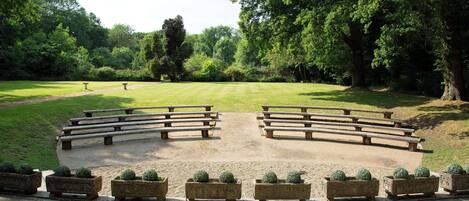 A park with picnic tables and planters.