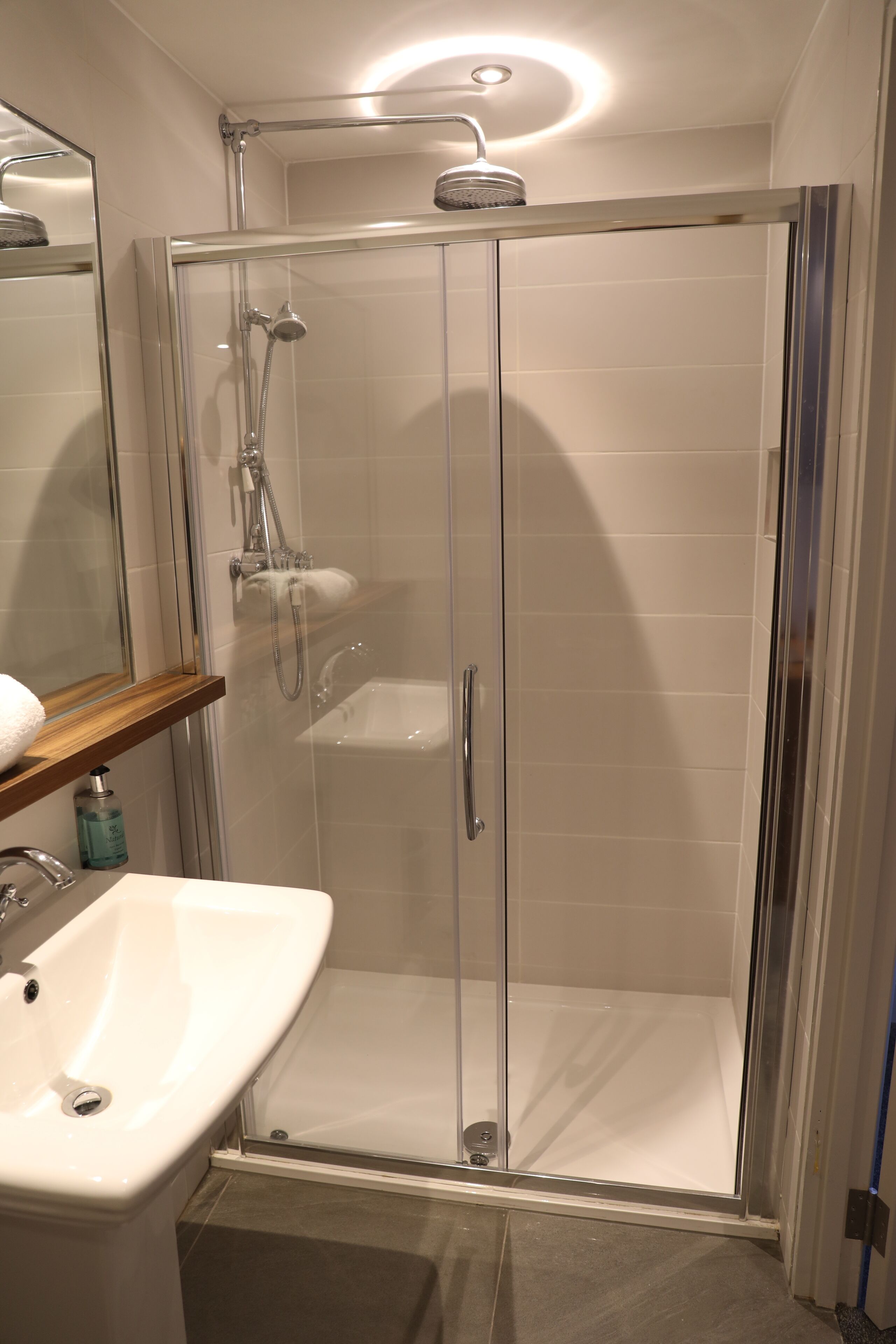 shower, designer toiletries, hair dryer, towels