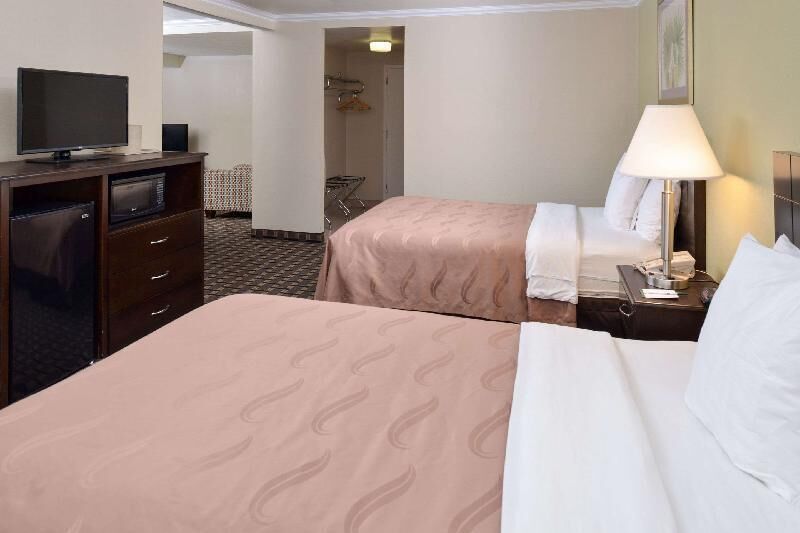 Premium bedding, desk, laptop workspace, blackout curtains