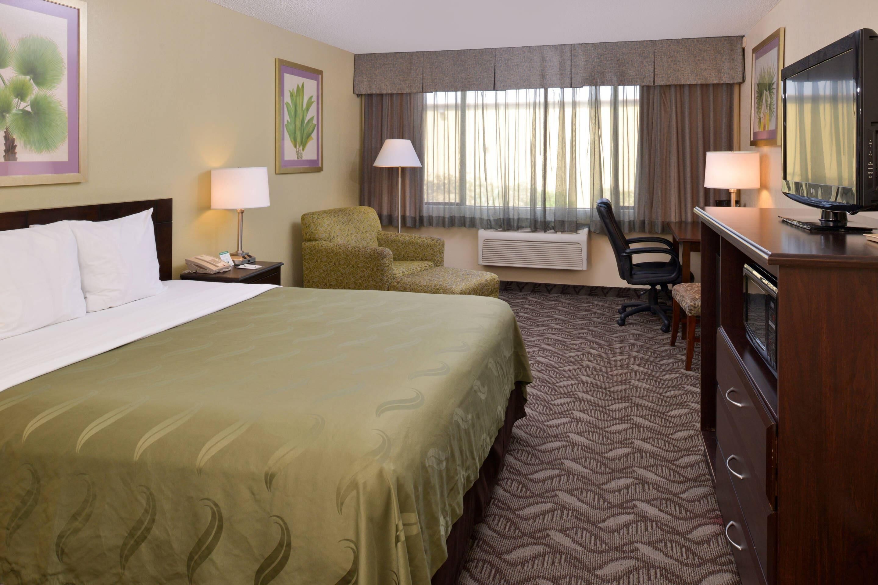 Premium bedding, desk, laptop workspace, blackout drapes