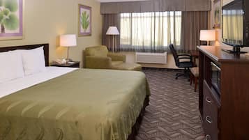 Premium bedding, desk, laptop workspace, blackout drapes