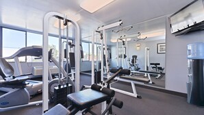 A gym with cardio machines, weightlifting equipment, and a water dispenser. - Quality Inn & Suites Montebello - Los Angeles (Montebello)
