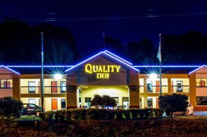 A hotel with a sign reading "QUALITY INN" and a well-lit entrance. - Quality Inn Tanglewood (Roanoke)