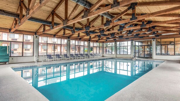 An indoor swimming pool with a wooden ceiling and large windows. - Quality Inn Cedar City - University Area (Cedar City)