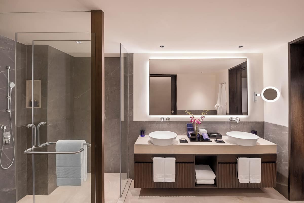 luxury residential suite | bathroom | separate bathtub and shower, deep-soaking bathtub, designer toiletries