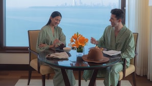 A room with a large window, a glass table, and two chairs. - The Oberoi Mumbai (Mumbai)