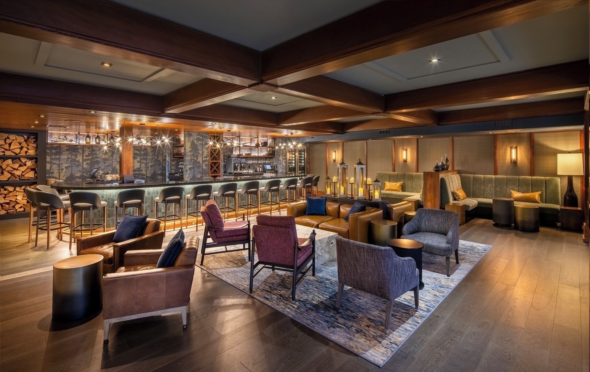 A spacious lobby with a bar area, leather seating, and a patterned rug.