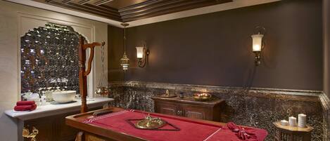 A room with a pool table, a mirror, and a decorative wall with a mosaic pattern.