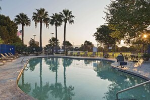 Seasonal outdoor pool, open 9:00 AM to 9:00 PM, pool loungers