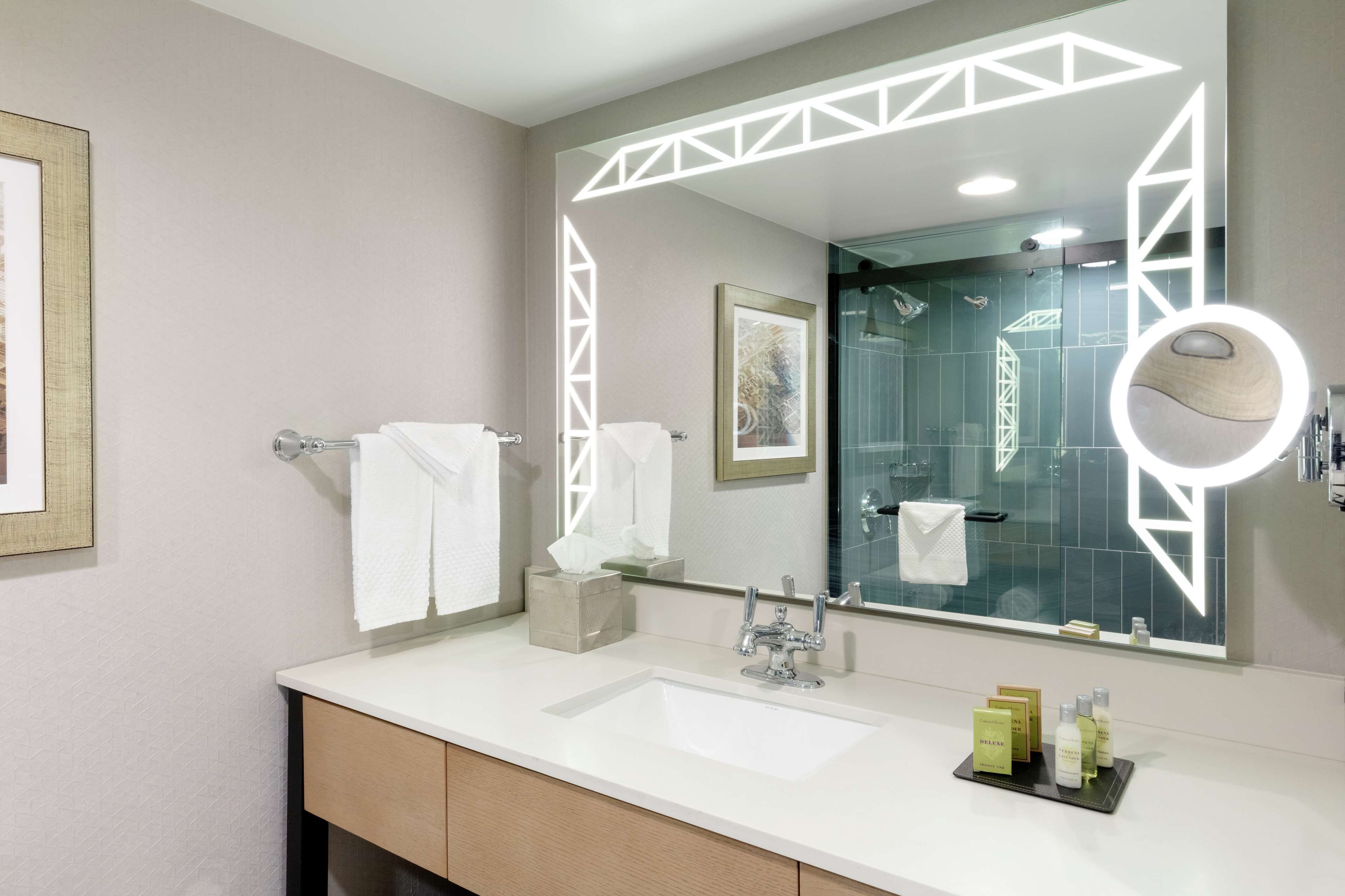 combined shower/bathtub, designer toiletries, hair dryer, towels