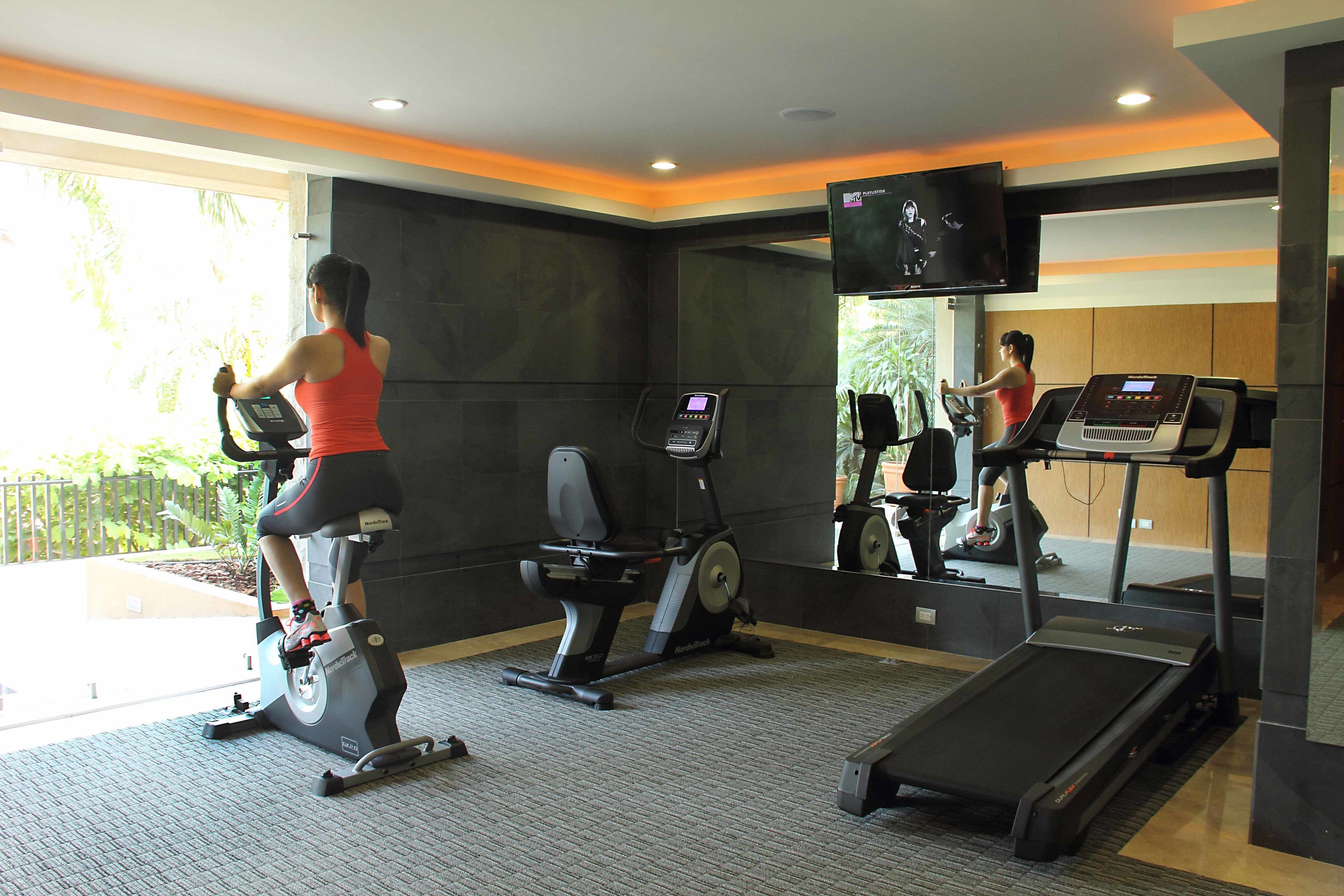 A gym with stationary bikes, an elliptical, and a treadmill.