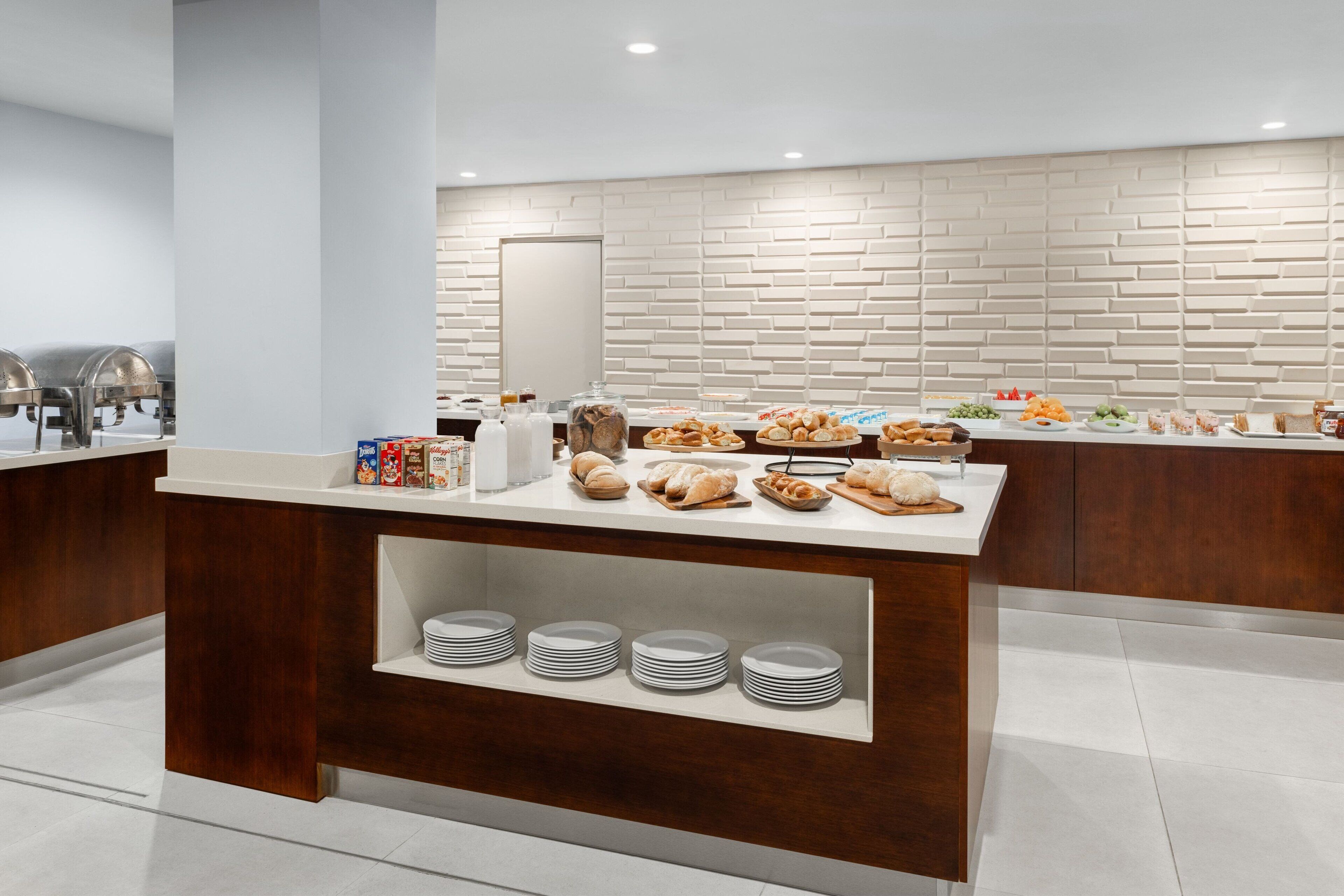 A modern breakfast buffet with a variety of pastries, fruits, and beverages.