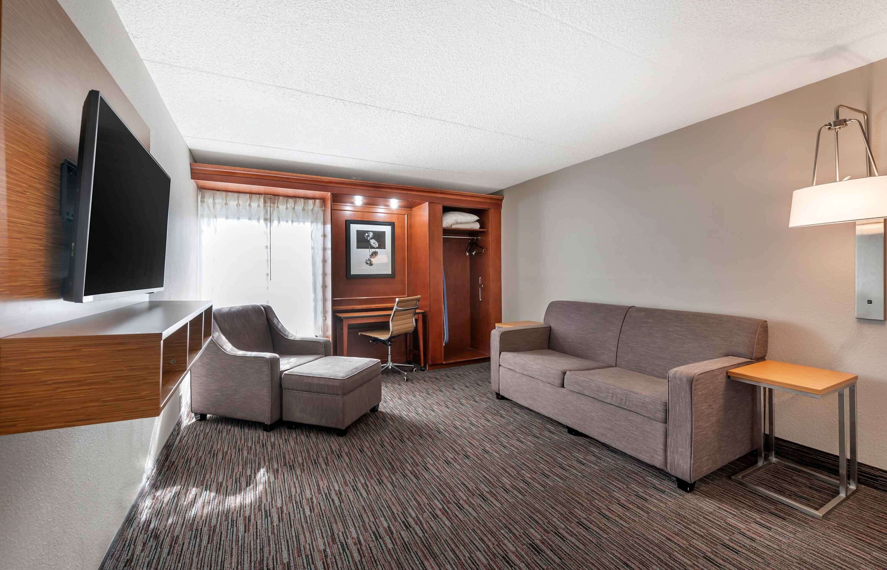 Desk, laptop workspace, blackout drapes, iron/ironing board