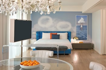 A high-rise building with a large billboard featuring a person. at The Valorian Los Angeles, Curio Collection by Hilton