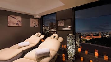 Relax in style with our serene relaxation area, featuring two reclining massage chairs and a city view.