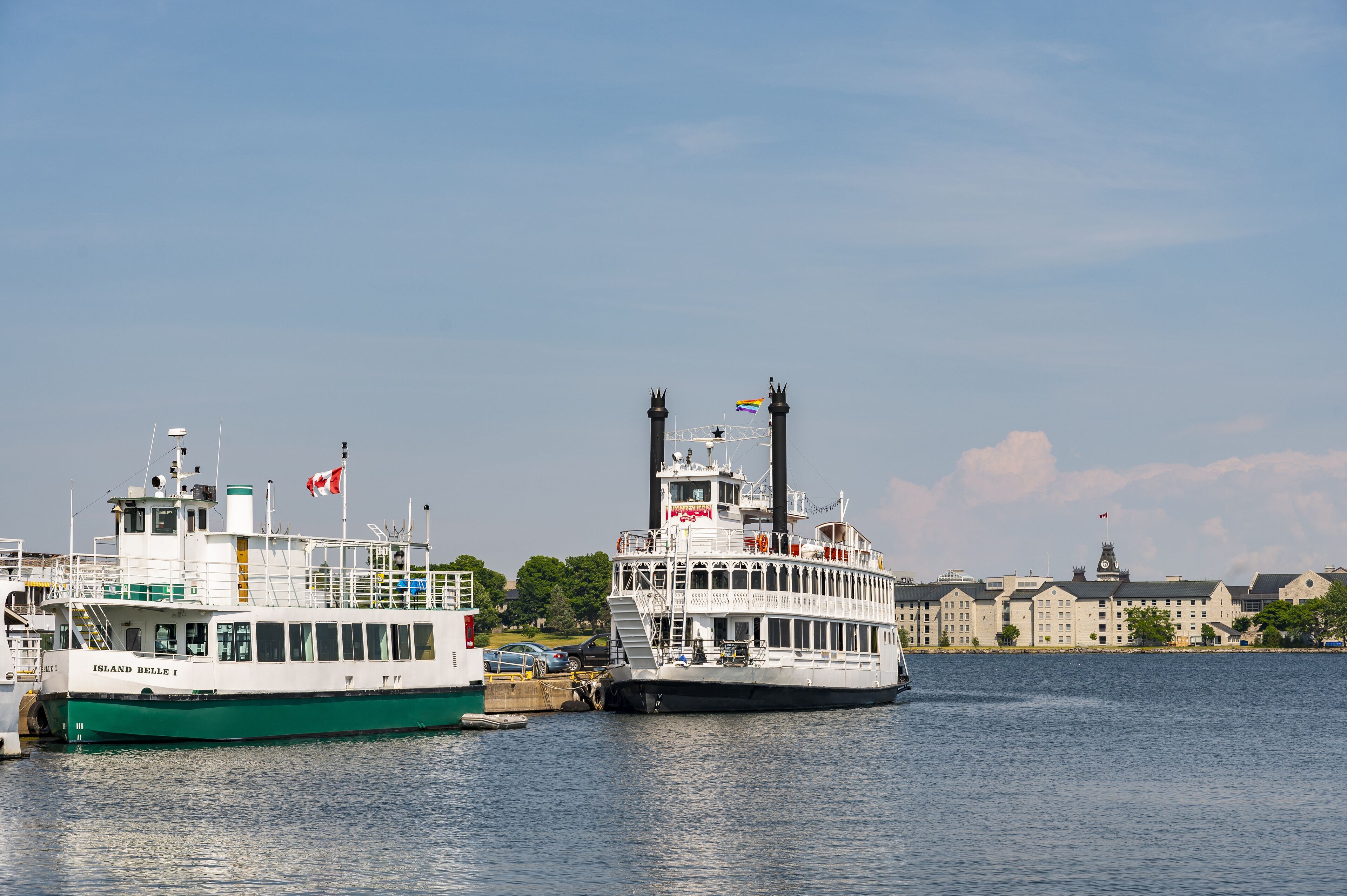Two boats docked at a marina with a building in the background.