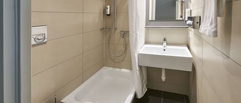 A modern bathroom with a bathtub, toilet, and sink.