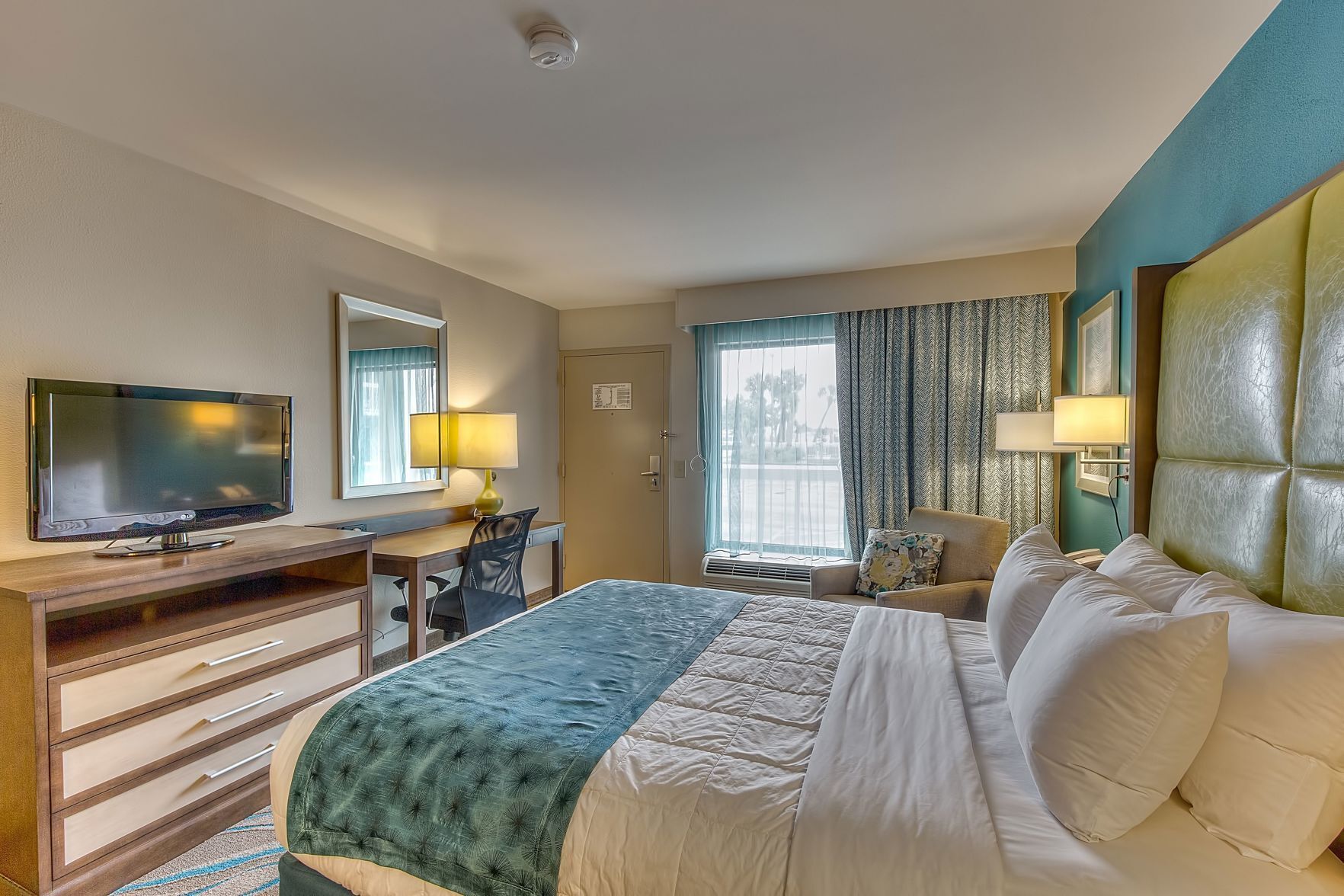 Premium bedding, desk, laptop workspace, blackout drapes