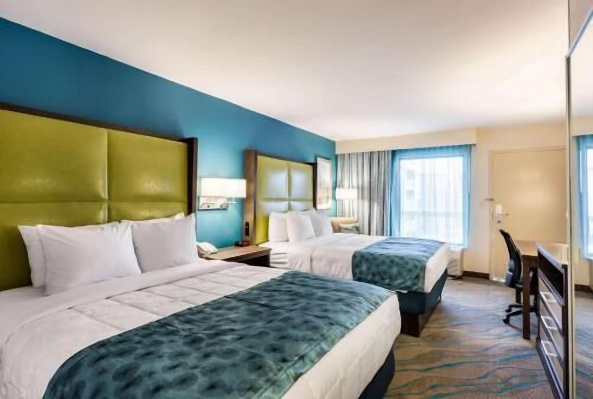 Premium bedding, desk, laptop workspace, blackout drapes