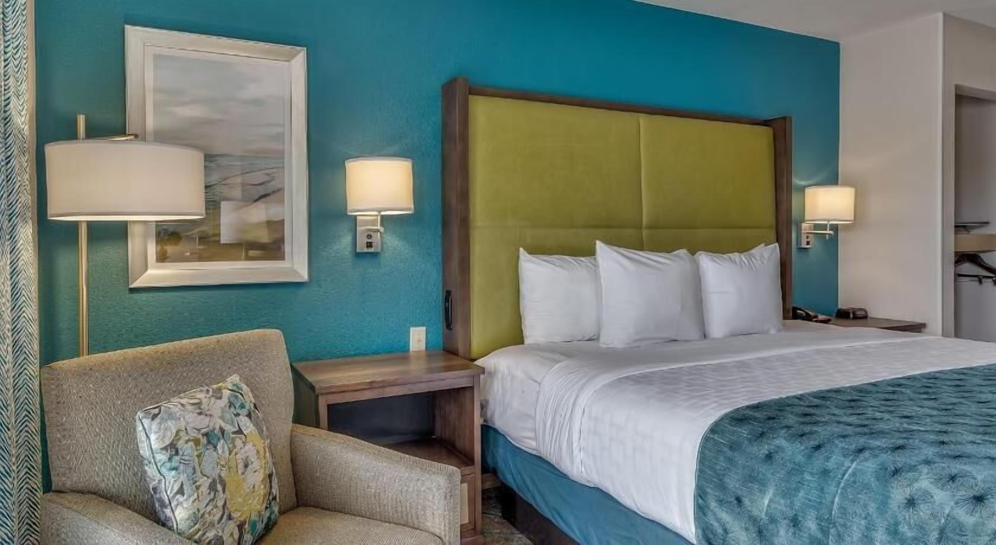 Premium bedding, desk, laptop workspace, blackout drapes
