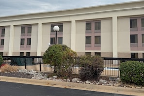 A multi-story building with a flat facade, large windows, and a central light fixture. - Comfort Inn Joplin I-44 (Joplin)