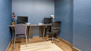 A room with a blue textured wall, two computer monitors, a desk, two chairs, and a small plant. - Best Western Danbury/Bethel (Bethel)