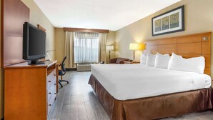 A hotel room with a large bed, a desk with a computer, a television, and a window with curtains. - Best Western Danbury/Bethel (Bethel)
