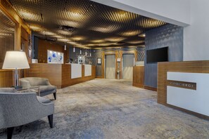 A modern lobby with a reception desk, seating area, and a unique ceiling design. - Best Western Premier Chateau Granville Hotel & Suites & Conf. Centre (Vancouver)