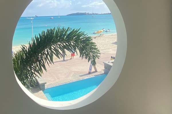 On the beach, white sand, beach cabanas, sun loungers