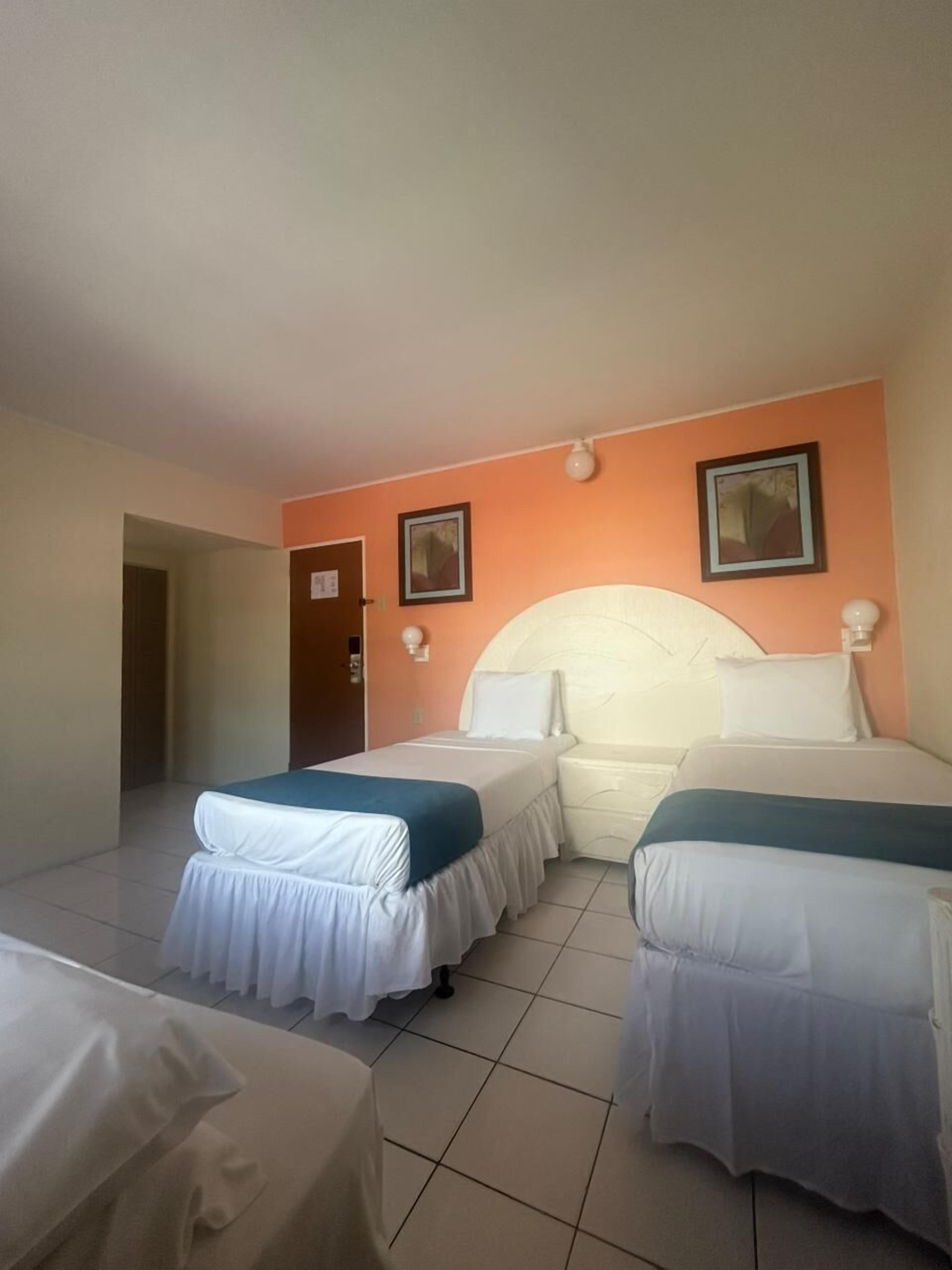 Habitación triple, vistas a la ciudad | Caja fuerte, escritorio, espacio para trabajar con un portátil