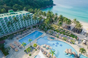 Relax by the pool or on the beach, surrounded by palm trees and ocean views.