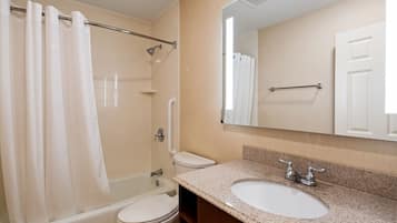 A bathroom with a bathtub, toilet, and sink.