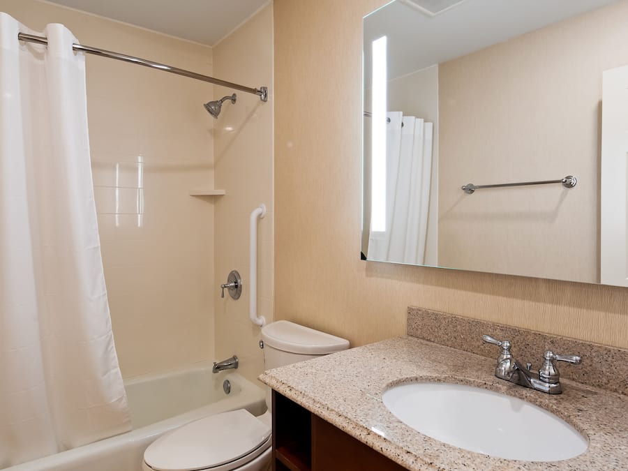 A bathroom with a bathtub, toilet, and sink.