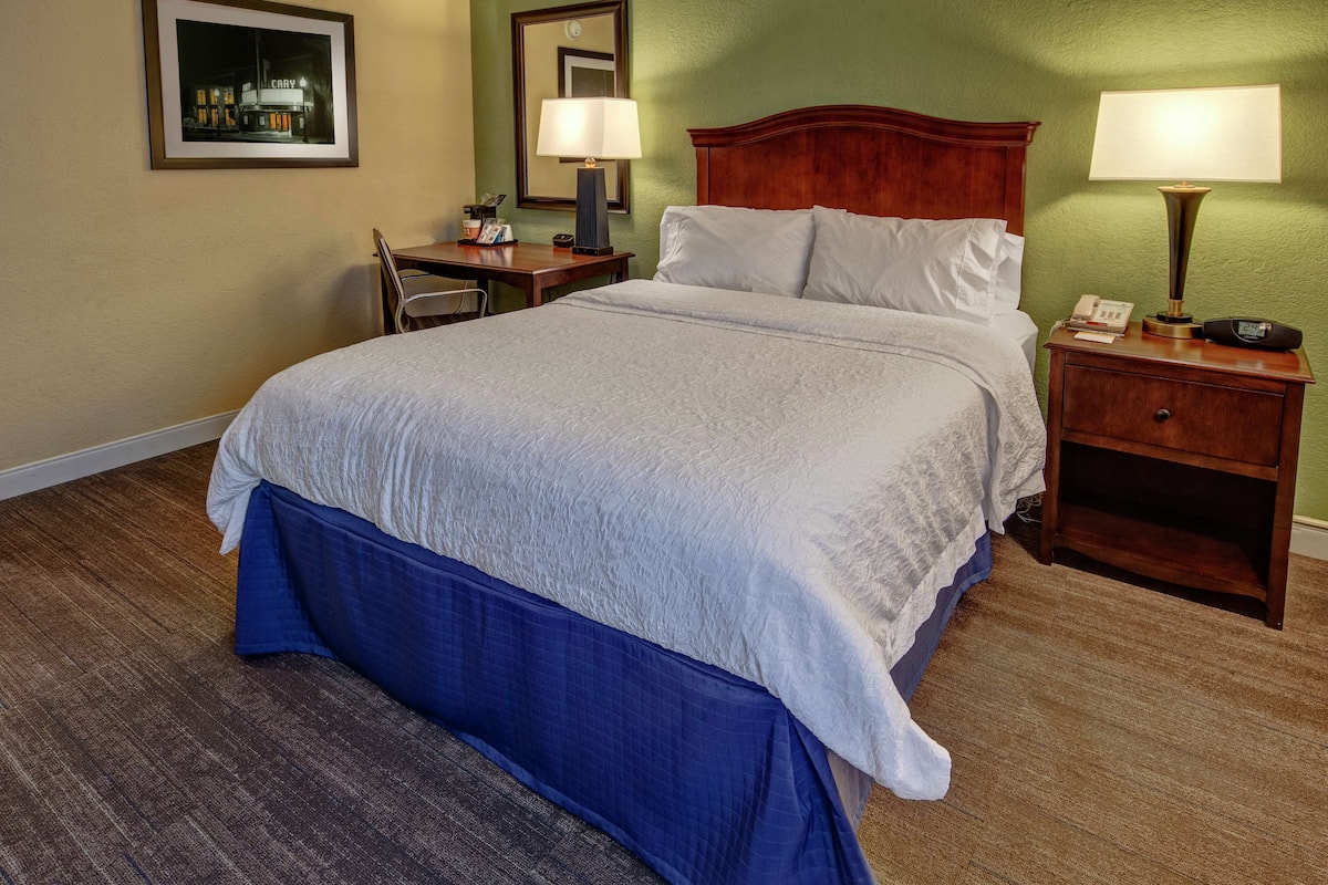 Premium bedding, desk, laptop workspace, blackout drapes
