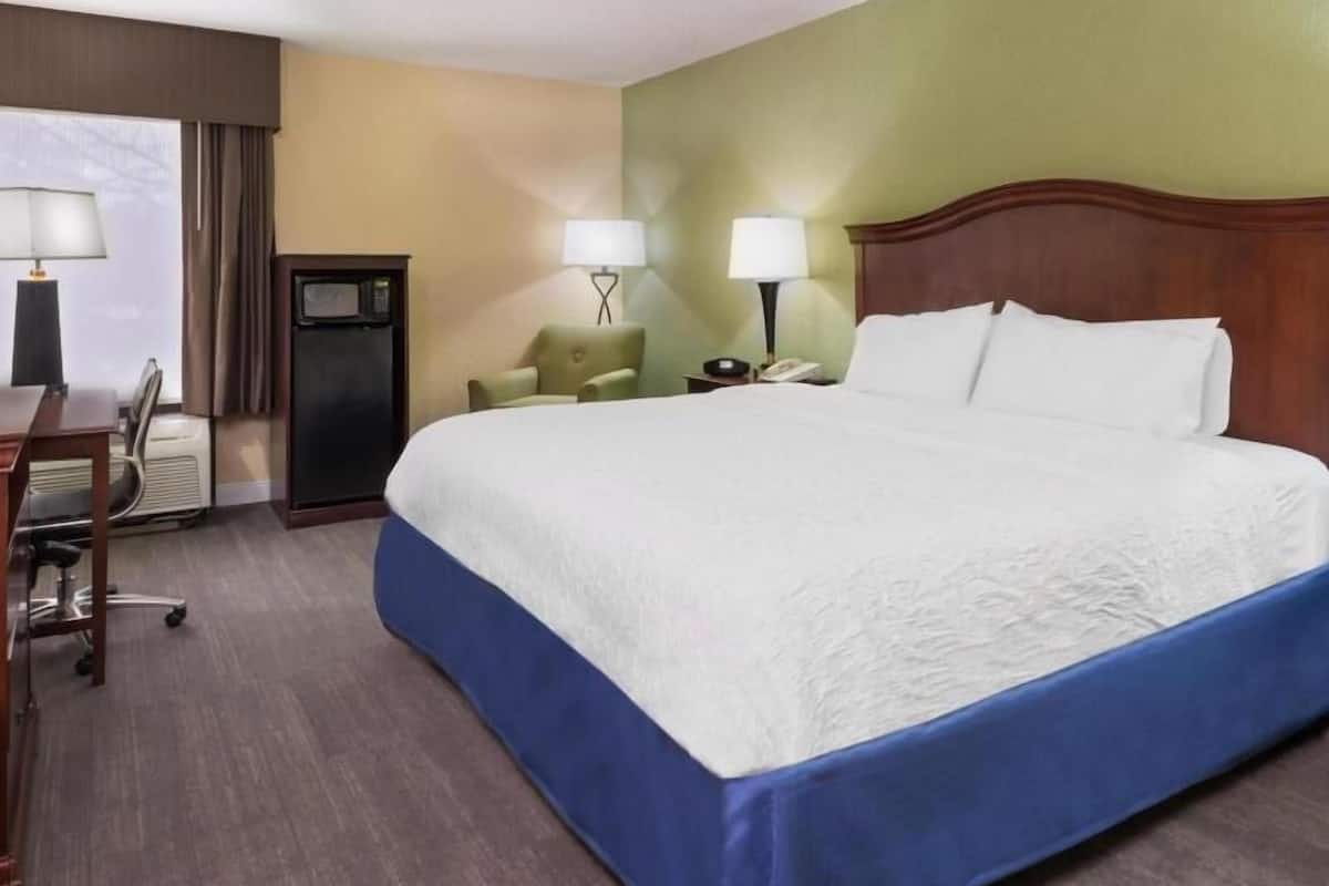 Premium bedding, desk, laptop workspace, blackout drapes