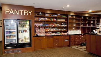A pantry with shelves stocked with snacks, beverages, and other food items.